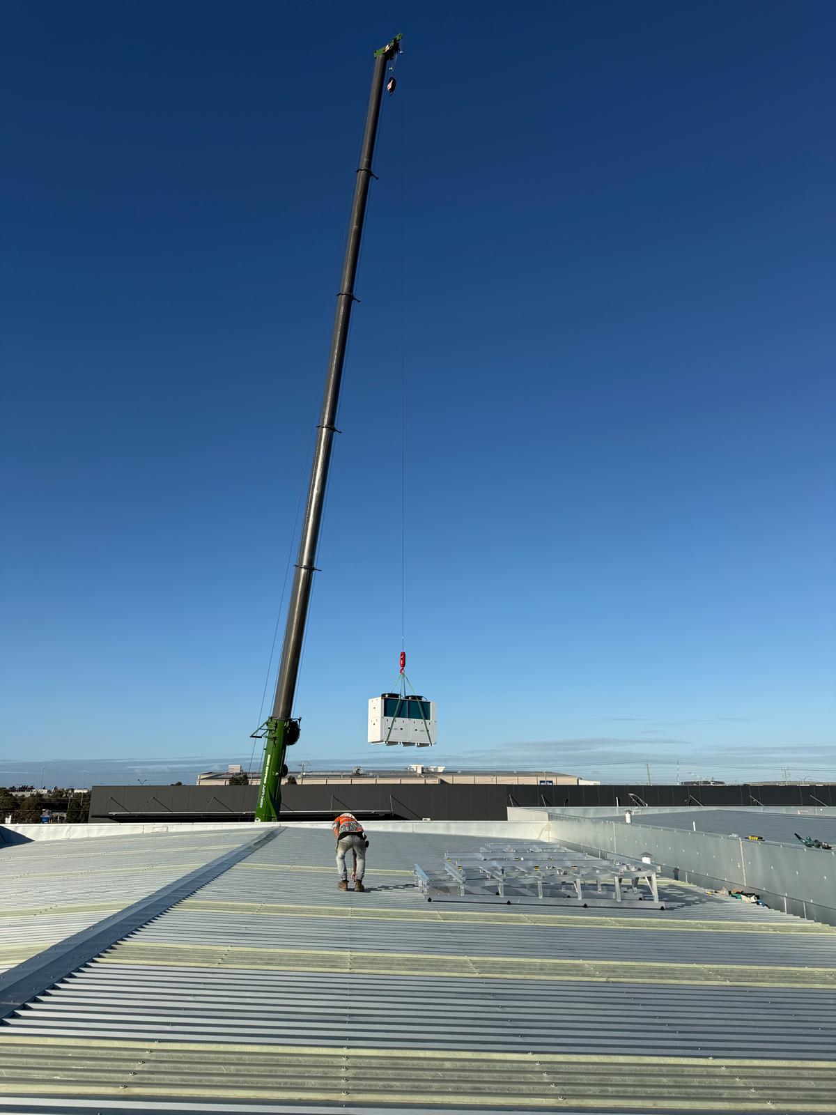 Commercial kitchen equipment lifted onto a rooftop